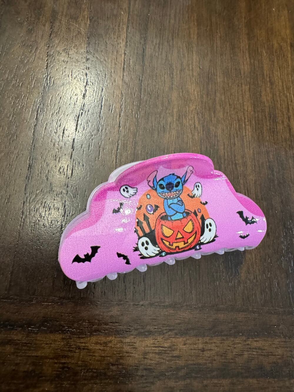 Stitch Halloween hair clip Stitch sitting on a jack-o'-lantern ghosts and bats